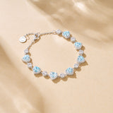 Bracelet en argent sterling Tennis Aquamarine de la pierre de naissance de mars FANCIME "Ms Charming" Halo Heart