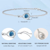 "Infinite Embrace" Bracelet en argent sterling avec topaze londonienne, symbole de l'infini, pierre de naissance de décembre